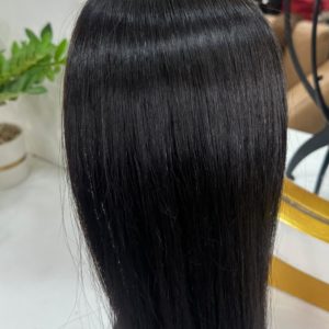 Smooth, silky black hair extensions displayed on a mannequin head, reflecting a natural shine with a sleek and straight texture.