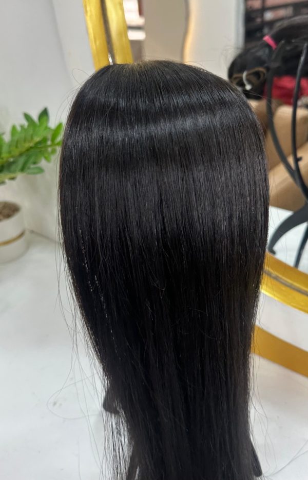 Smooth, silky black hair extensions displayed on a mannequin head, reflecting a natural shine with a sleek and straight texture.